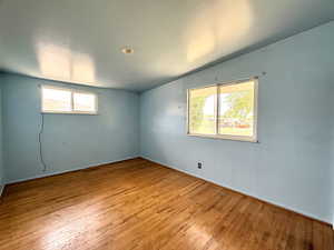 Unfurnished room featuring healthy amount of natural light and hardwood / wood-style flooring