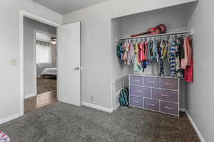 Bedroom featuring dark colored carpet