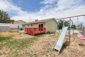 Back of house with a deck