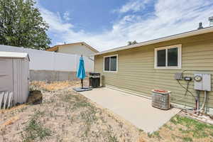 View of yard featuring a patio area and a storage unit