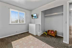 Unfurnished bedroom with carpet floors and baseboards