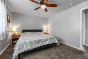 Bedroom with ceiling fan and carpet floors