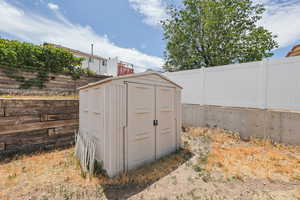 View of shed with a fenced backyard