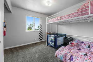 Carpeted bedroom featuring baseboards