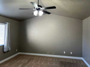 Master Bedroom with dark carpet, a ceiling fan, vaulted ceiling, and a textured ceiling