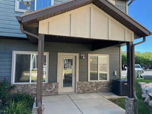 Property patio featuring stone and siding