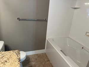 Master bath with toilet and a tub to relax in