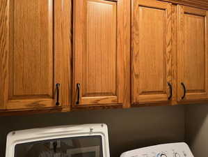 Laundry area with cabinet space and washer / clothes dryer
