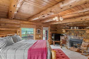 Bedroom #1 on main floor featuring a stone fireplace and beautiful mountain views