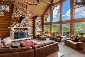 A stone fireplace, views of Beaver Mountain Ski Resort and natural light in the great room