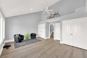 Sitting room featuring ceiling fan, high vaulted ceiling, wood finished floors, and recessed lighting