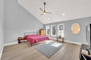 Bedroom featuring wood finished floors, recessed lighting, ceiling fan, and high vaulted ceiling