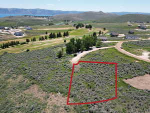 Aerial overview of property's location featuring property boundaries highlighted and a mountainous background