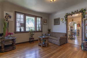 Living room featuring hardwood / wood-style flooring and baseboards