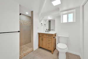Bathroom featuring walk in shower, vanity, and recessed lighting