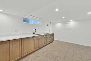 Kitchen with recessed lighting and light countertops