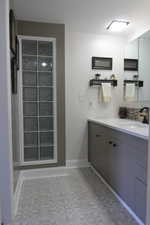 Bathroom featuring baseboards and vanity