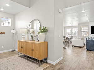 Hallway with light wood-type flooring and recessed lighting