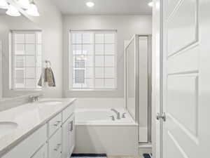 Bathroom with a stall shower, a bath, double vanity, and recessed lighting