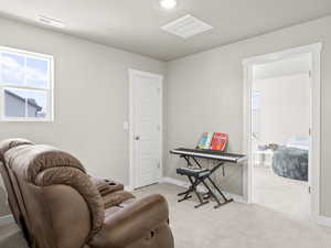 Sitting room featuring light carpet and recessed lighting