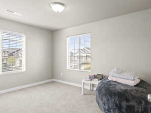 Bedroom featuring baseboards and light carpet