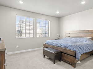 Bedroom with light carpet and recessed lighting