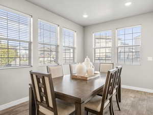 Dining area featuring light wood-style floors, plenty of natural light, and recessed lighting