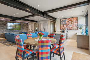 Dining area featuring beam ceiling and recessed lighting