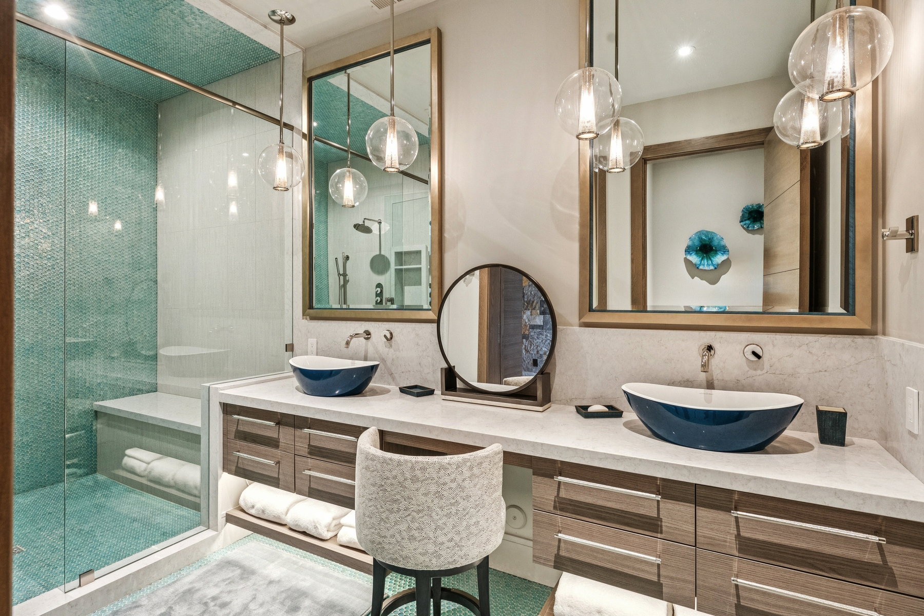 Full bathroom with a stall shower, double vanity, and backsplash