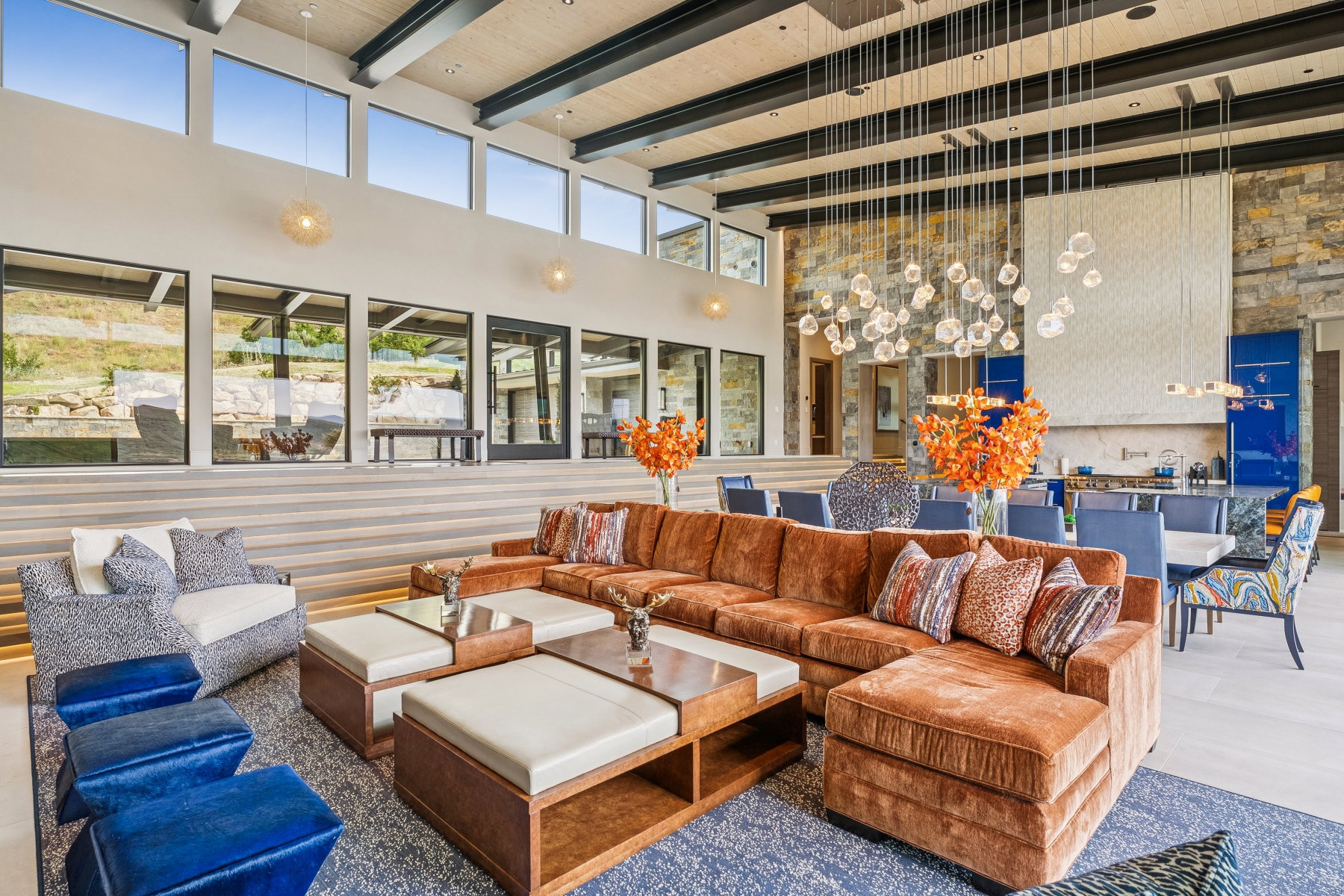 Living area with a high ceiling and a wooden ceiling with exposed beams