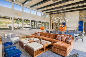 Living area with a high ceiling and a wooden ceiling with exposed beams