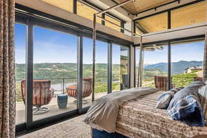 Bedroom with a mountain view and multiple windows