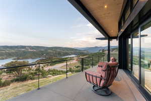 Balcony with a water and mountain view