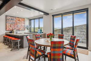 Dining room featuring wet bar, recessed lighting, and light tile patterned floors