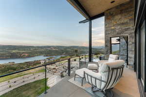 Balcony with a water and mountain view