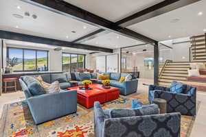 Common area featuring stairs, beamed ceiling, and recessed lighting