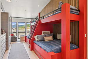 Bedroom with light tile patterned floors, a mountain view, recessed lighting, and access to exterior