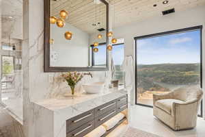 Full bath featuring vanity and plenty of natural light