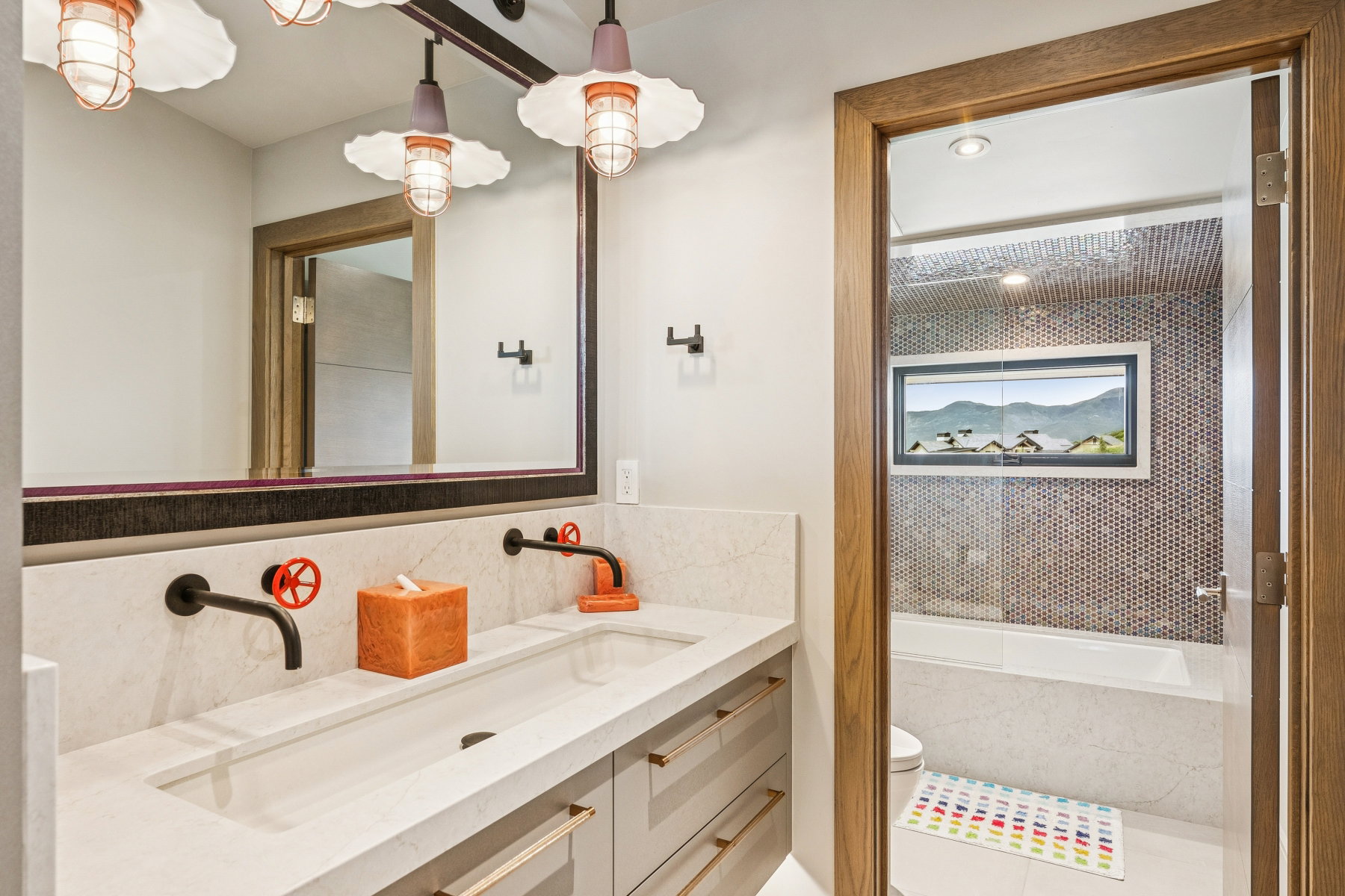 Bathroom featuring tasteful backsplash, vanity, and a tub to relax in