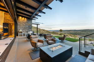 View of patio / terrace with a mountain view, an outdoor living space with a fire pit, and area for grilling