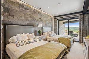 Bedroom featuring access to exterior and a fireplace