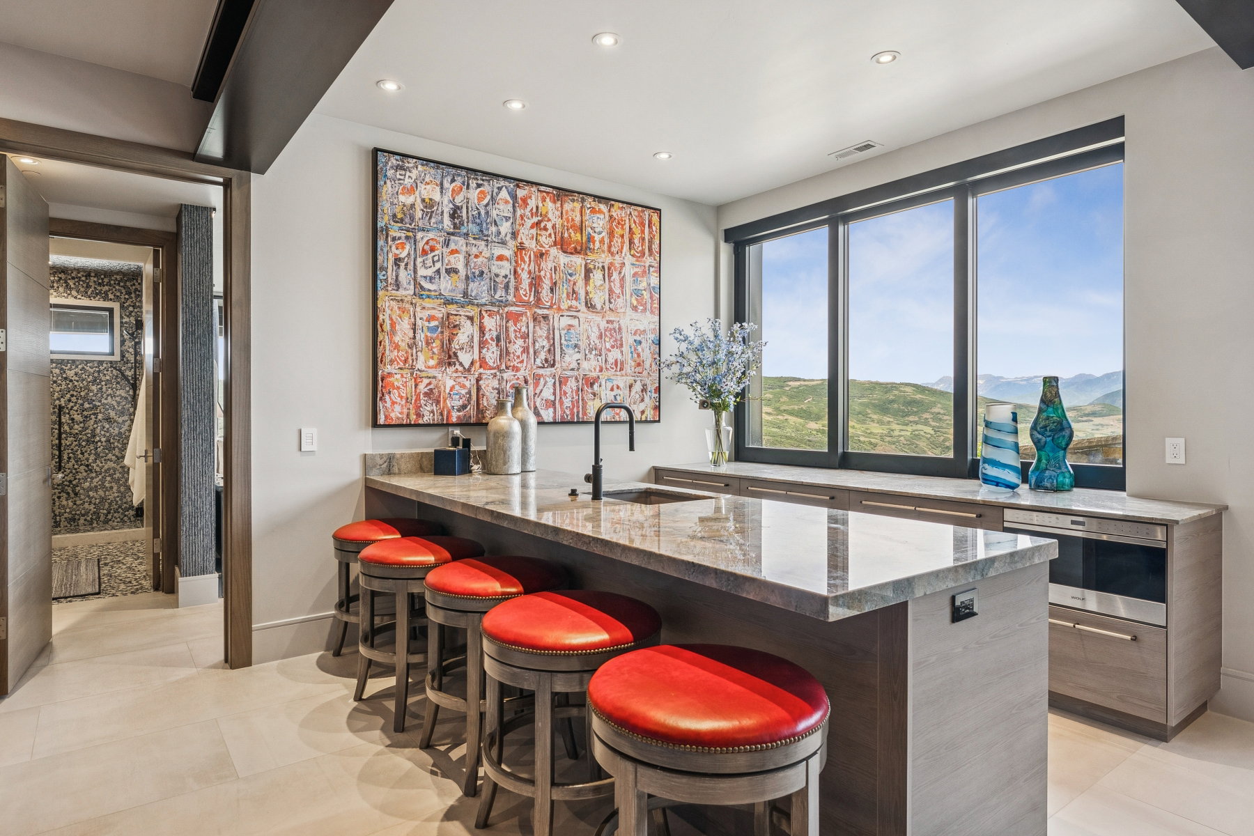 Indoor bar with light tile patterned flooring and recessed lighting