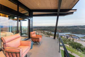 Patio / terrace featuring a water and mountain view