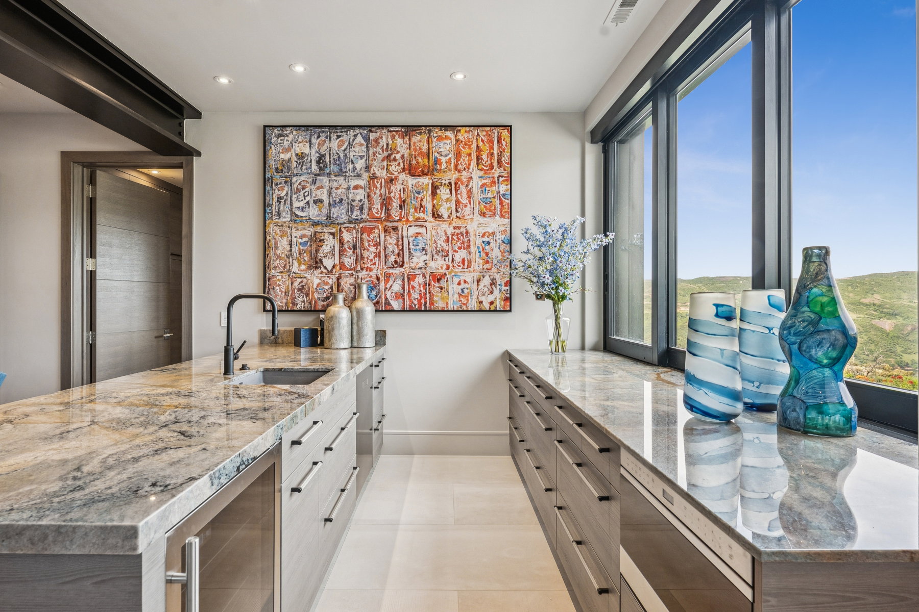 Kitchen featuring beverage cooler, recessed lighting, light stone counters, white cabinets, and a peninsula