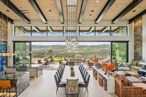 View of patio / terrace with outdoor dining space, a mountain view, and an outdoor living space