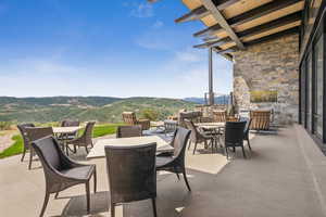 View of patio with outdoor dining space and a mountain view