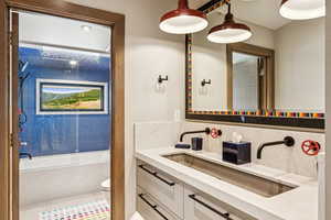 Full bath featuring tasteful backsplash, a bathtub, and vanity