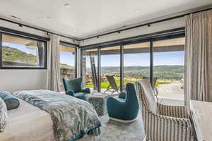 Bedroom featuring access to exterior and a mountain view