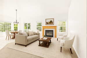 Living room with a high ceiling, a glass covered fireplace, a chandelier, and light tile patterned flooring. Staged with AI.