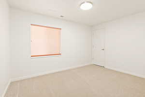 Carpeted empty room with baseboards
